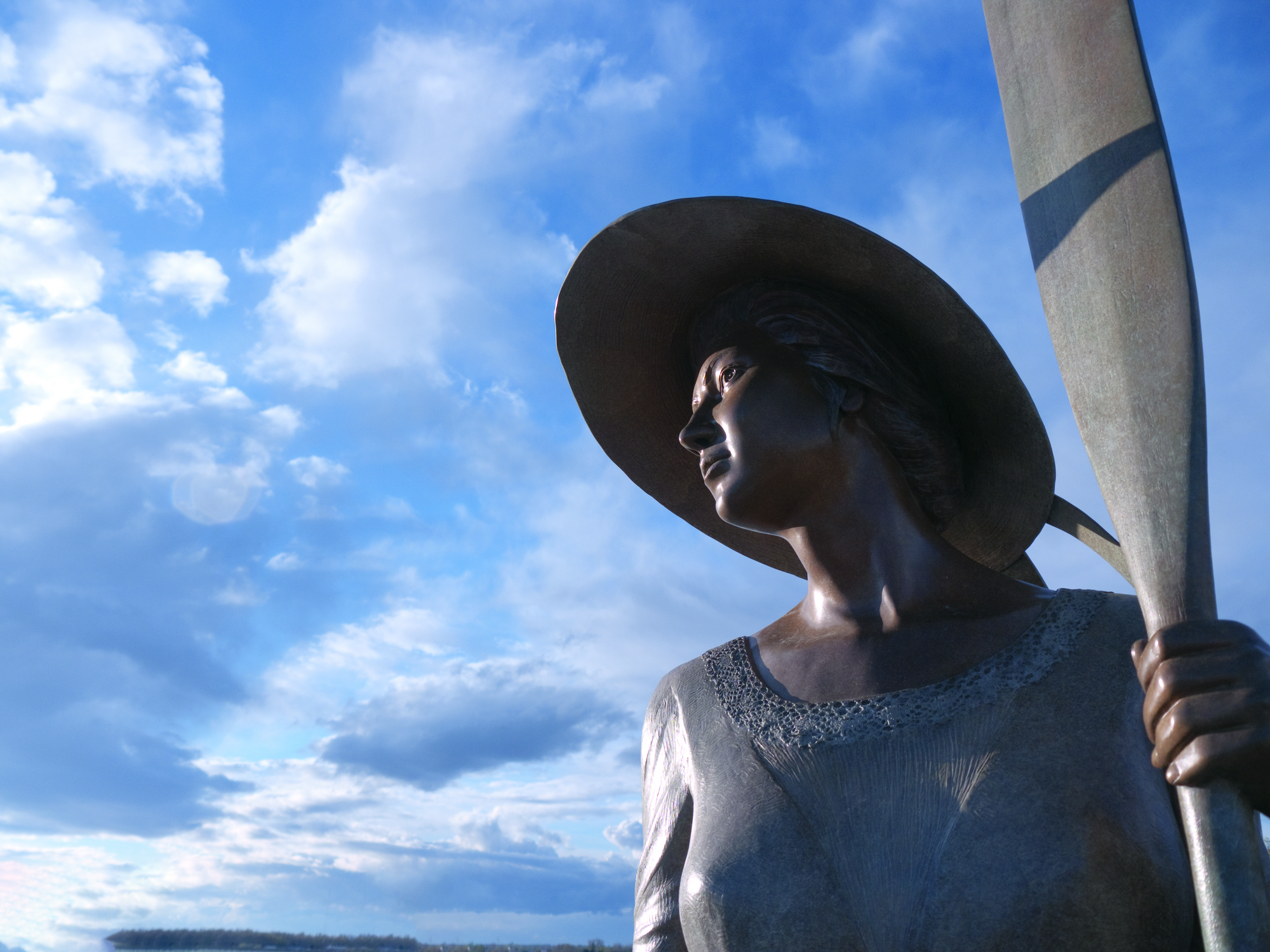 Statue of a woman holding an oar, looking out toward the water on Clover Island in Kennewick.