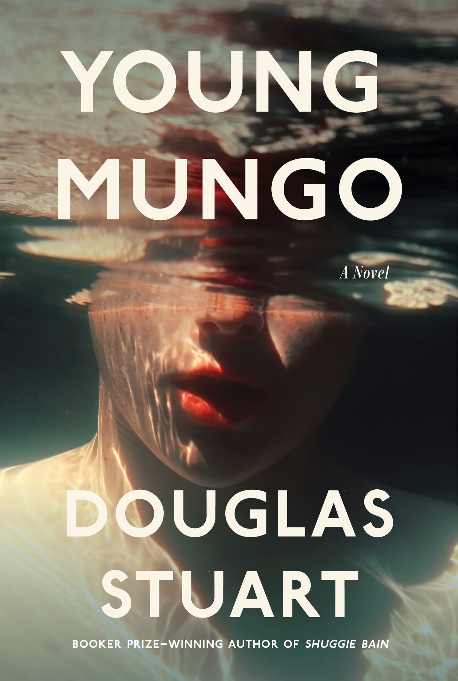 "Young Mungo, a novel by Douglas Stewart; Booker prize-winning author of Shuggie Bain" — Image shows a young man under water