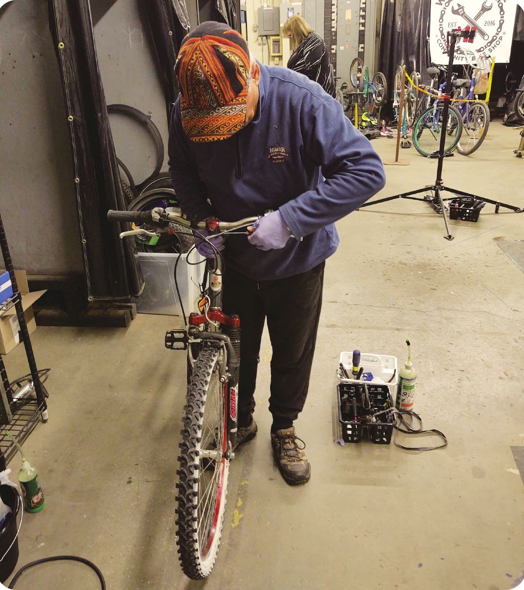 A volunteer works on a bike at Wheelhouse
