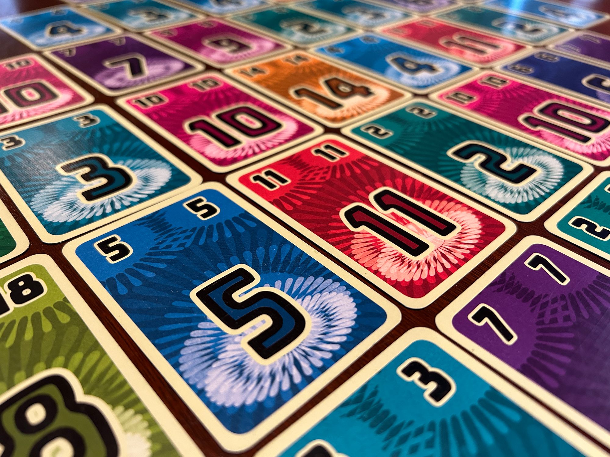 Closeup image of cards from the game Fuji Flush, featuring colorful designs with large numbers
