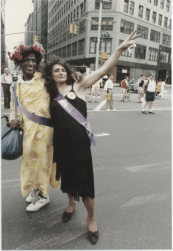 Marsha P. Johnson and Sylvia Rivera wave on the street