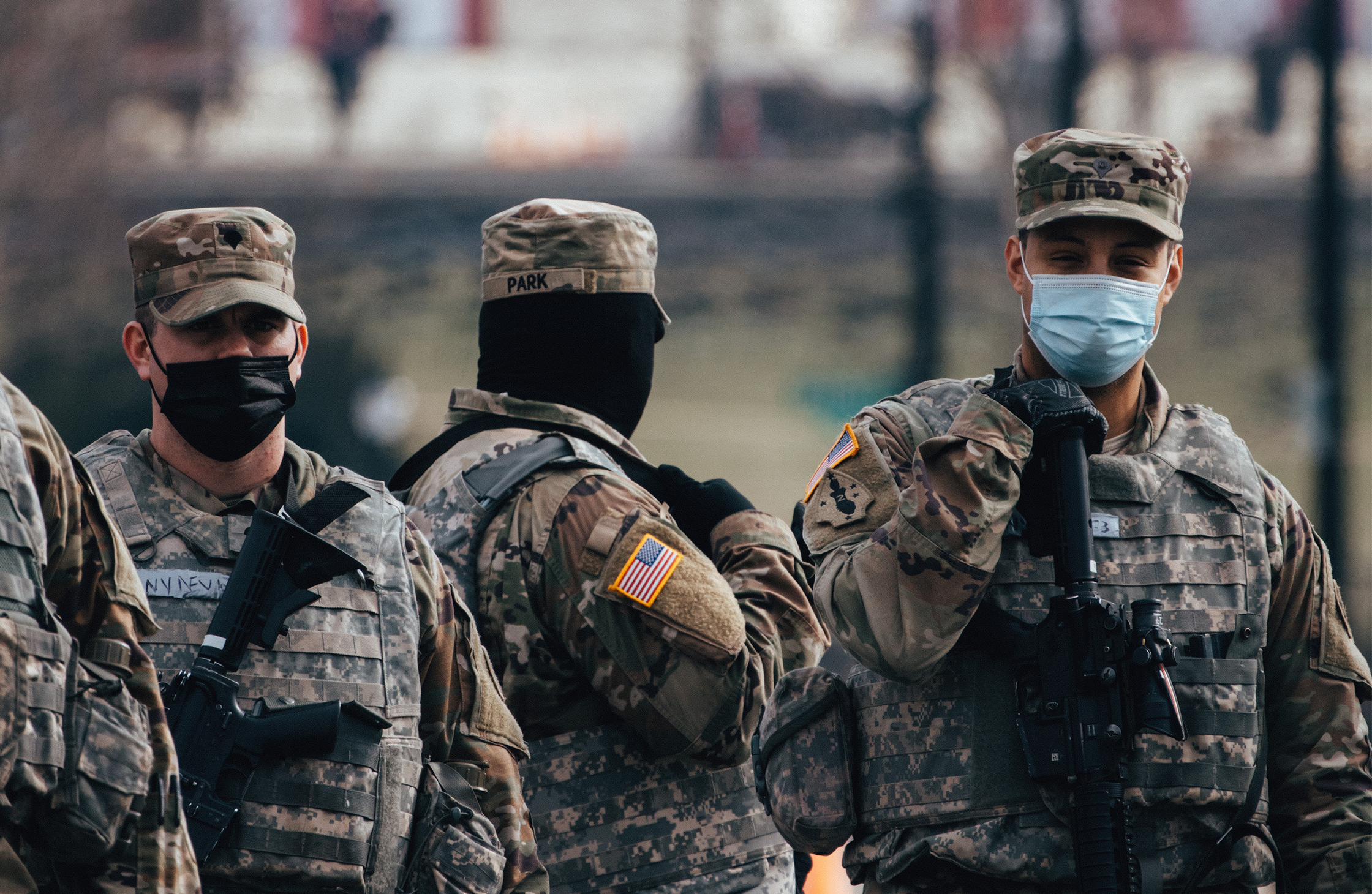 A photo of the National Guard on duty. They are wearing face masks and holding guns.