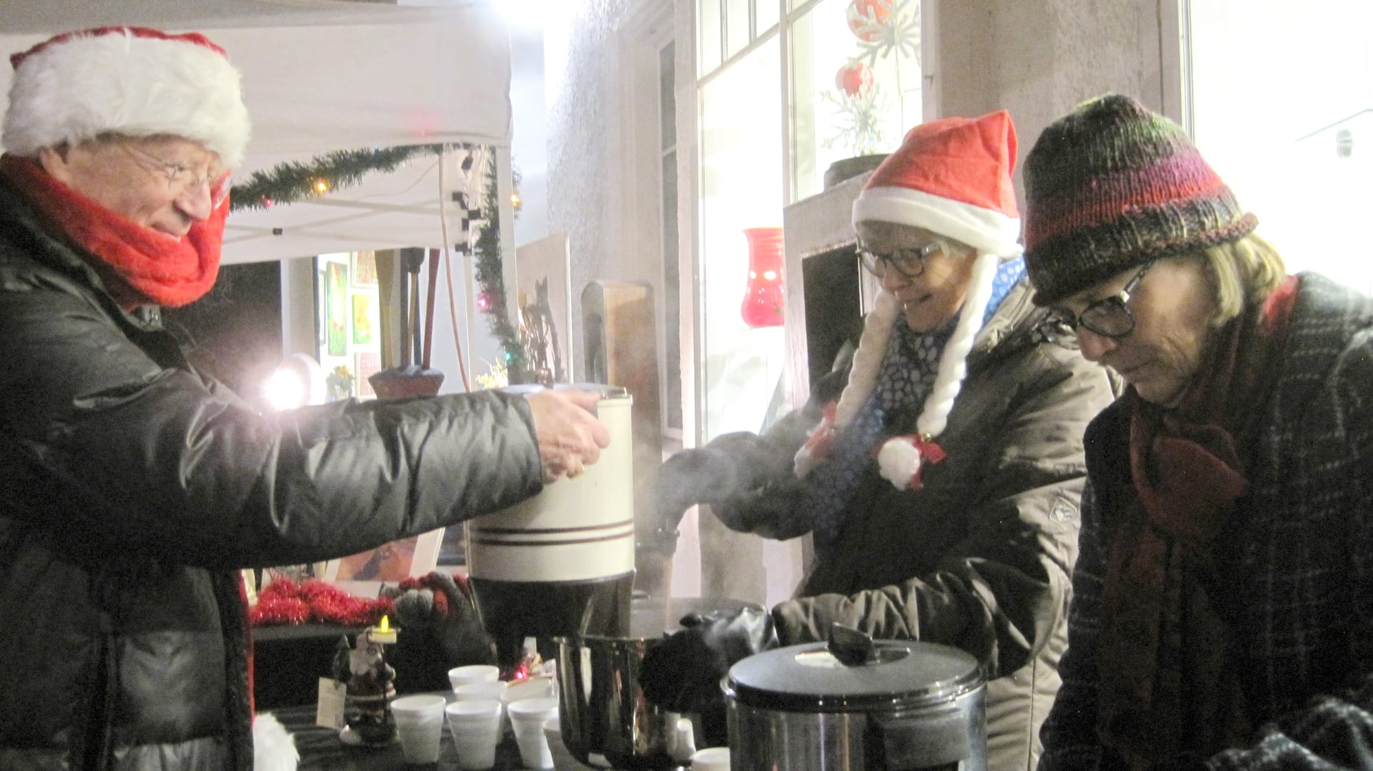 Image of people at the Gallery's Christmas market enjoying their complimentary hot chocolate.