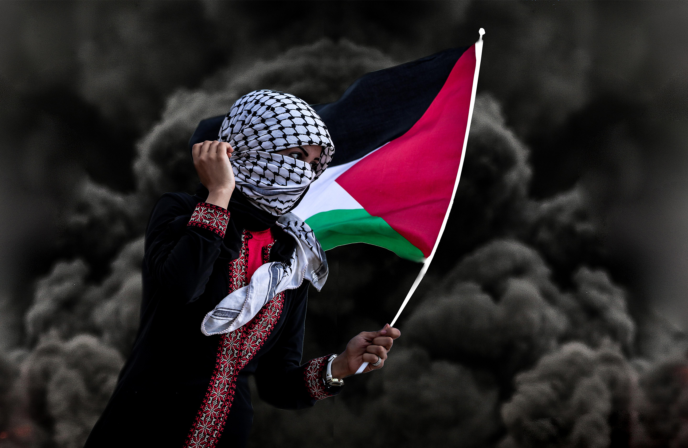 An image of a woman holding the Palestinian flag.