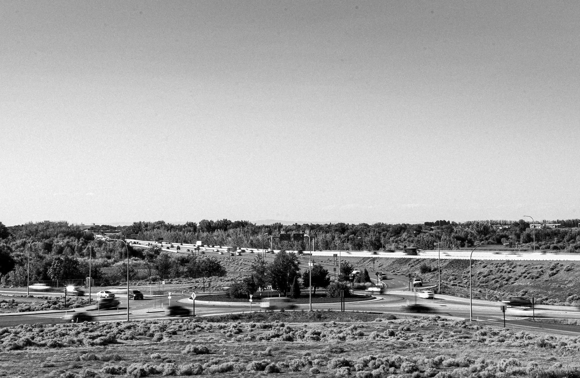 A black-and-white image of a roundabout.